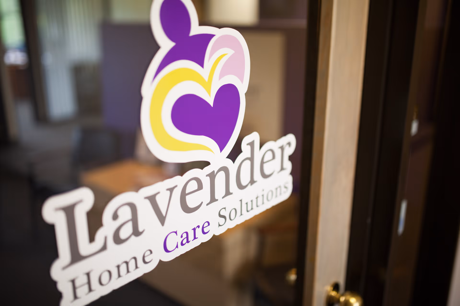 Glass door displays Lavender Home Care Solutions logo with a blurred interior behind.