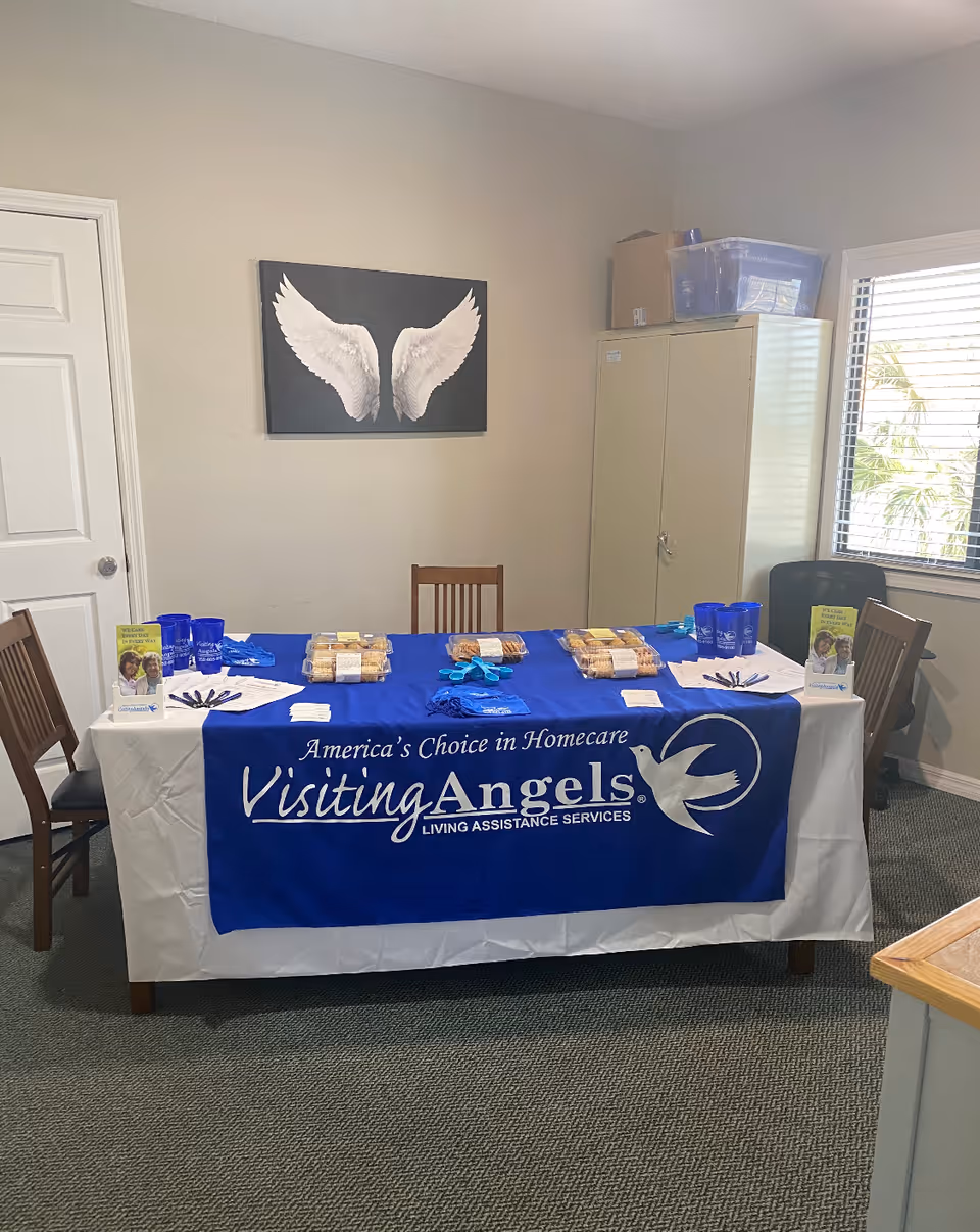 Indoor room featuring a blue Visiting Angels table with promotional materials.