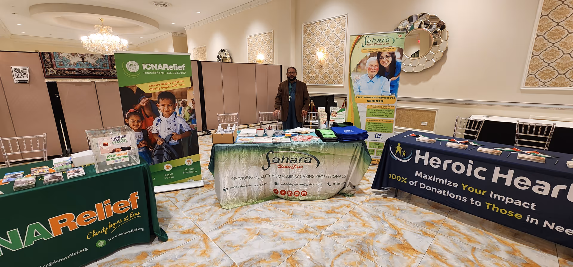 Indoor lobby with exhibition tables and banners for Sahara Home Care.