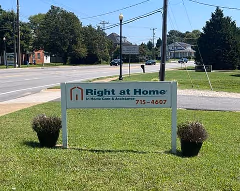 Front exterior sign reading Right at Home on a grassy lawn near the road.
