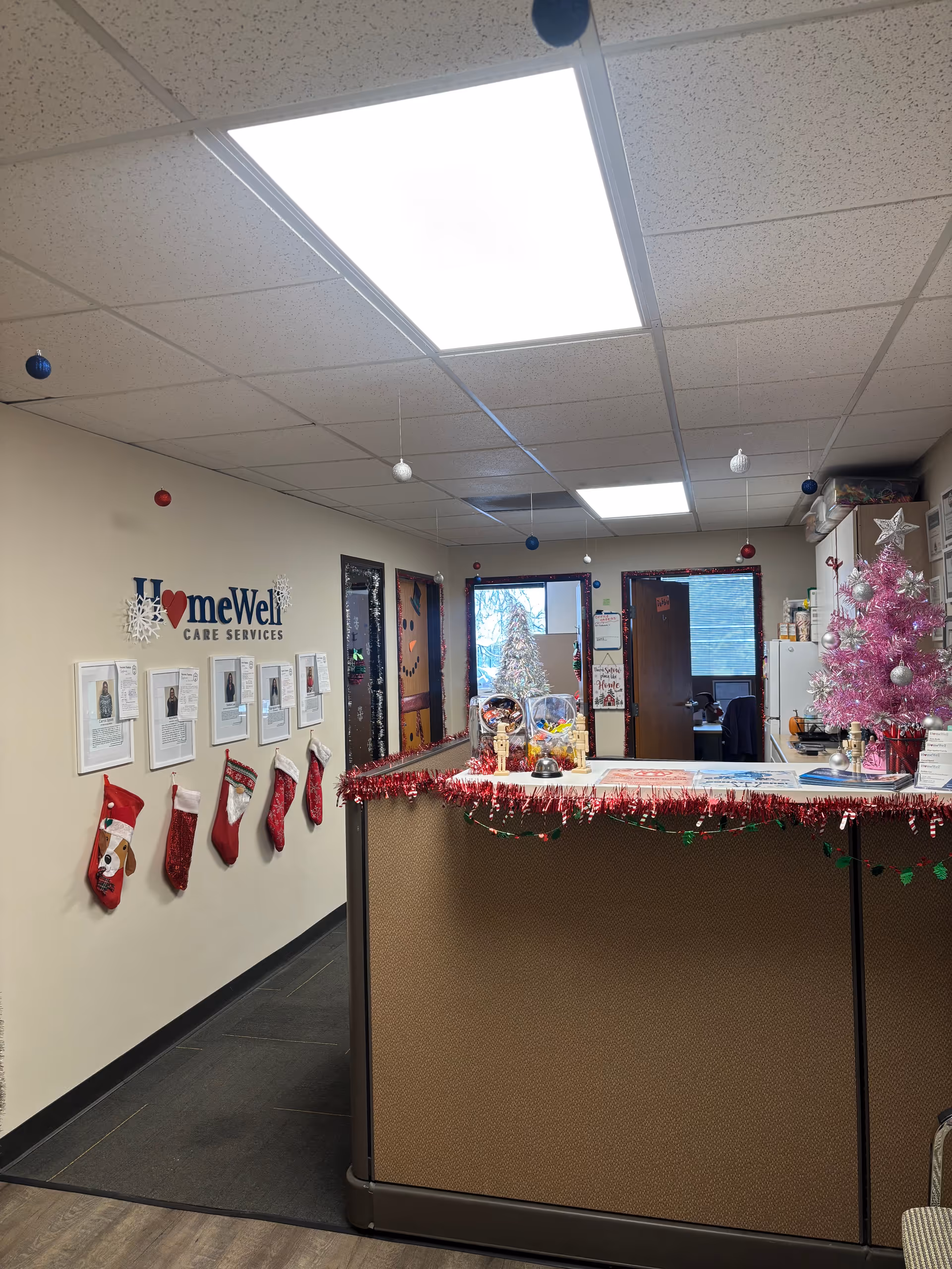 Front desk area with Christmas decorations in a HomeWell Care Services lobby.