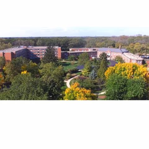 Aerial view of Cantata Adult Life Services campus with brick buildings and green trees