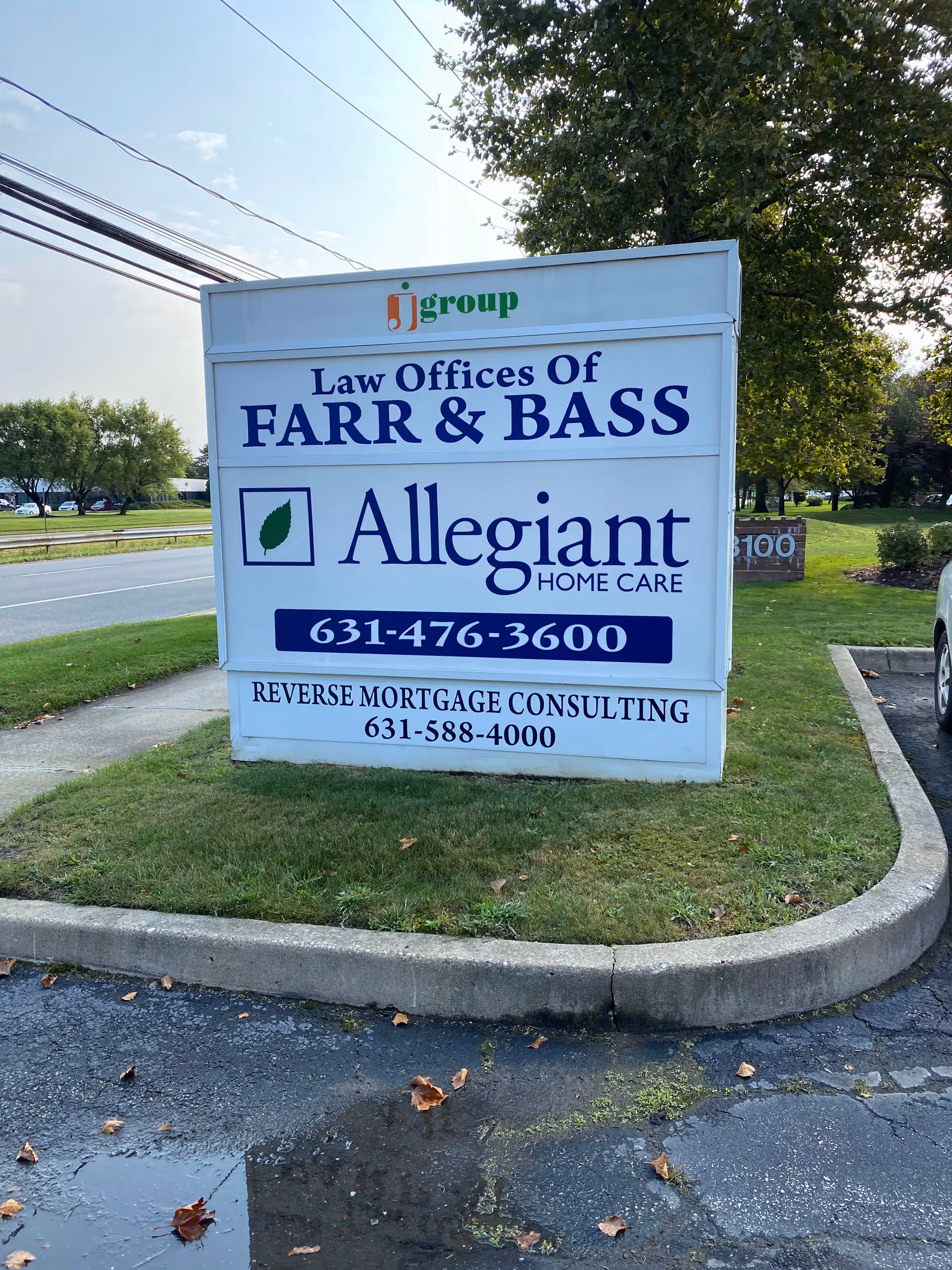 Roadside sign advertising Allegiant Home Care beside Farr & Bass law offices near a road