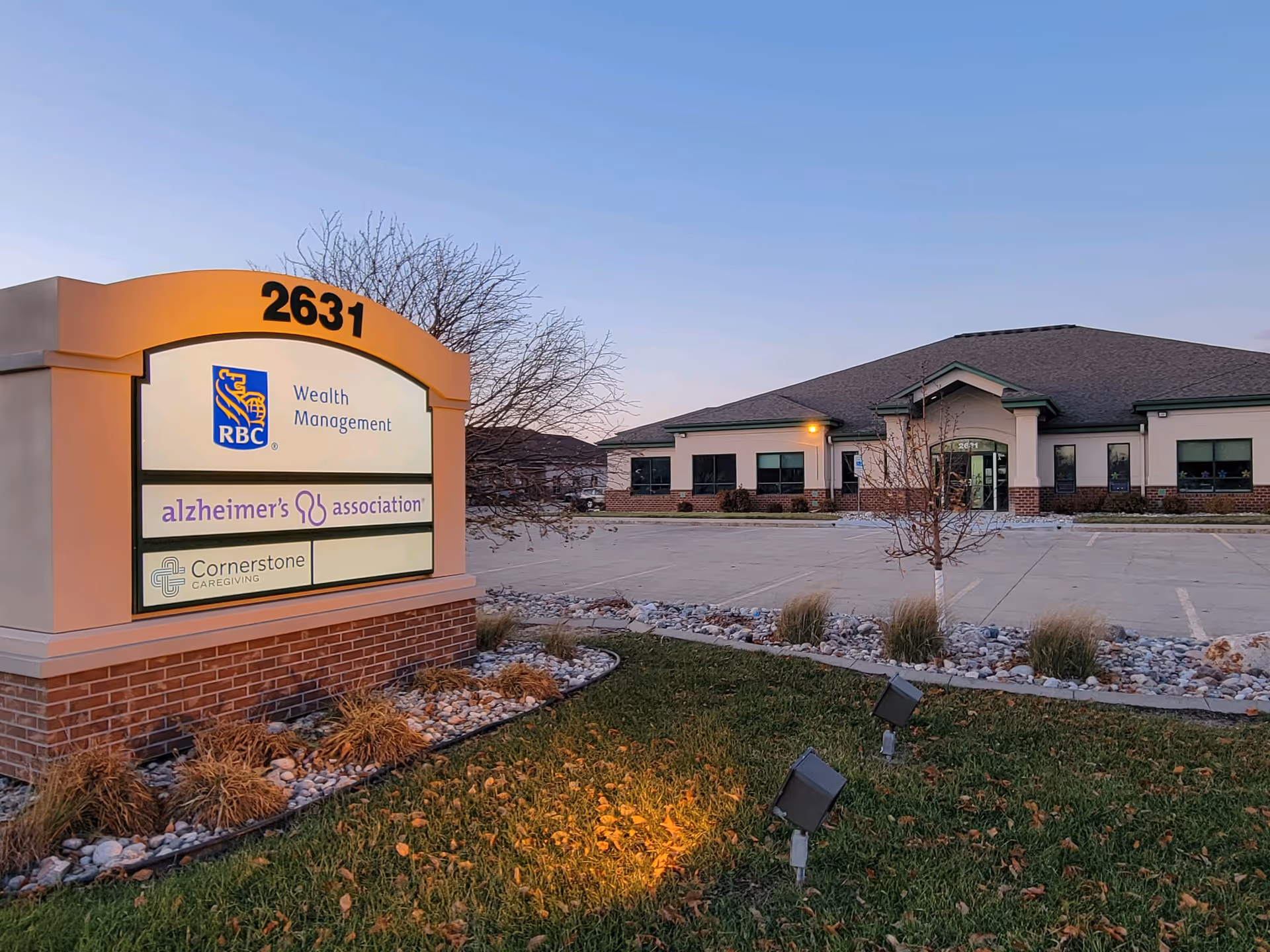 Exterior view of Cornerstone Caregiving facility with a sign and empty parking lot.