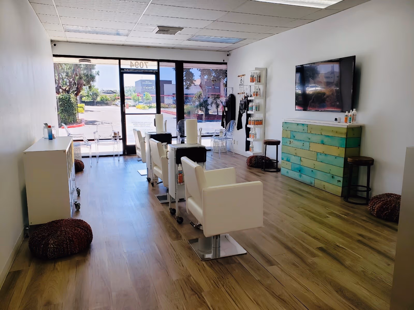 Bright senior living salon with white chairs, product shelves, and a glass storefront.
