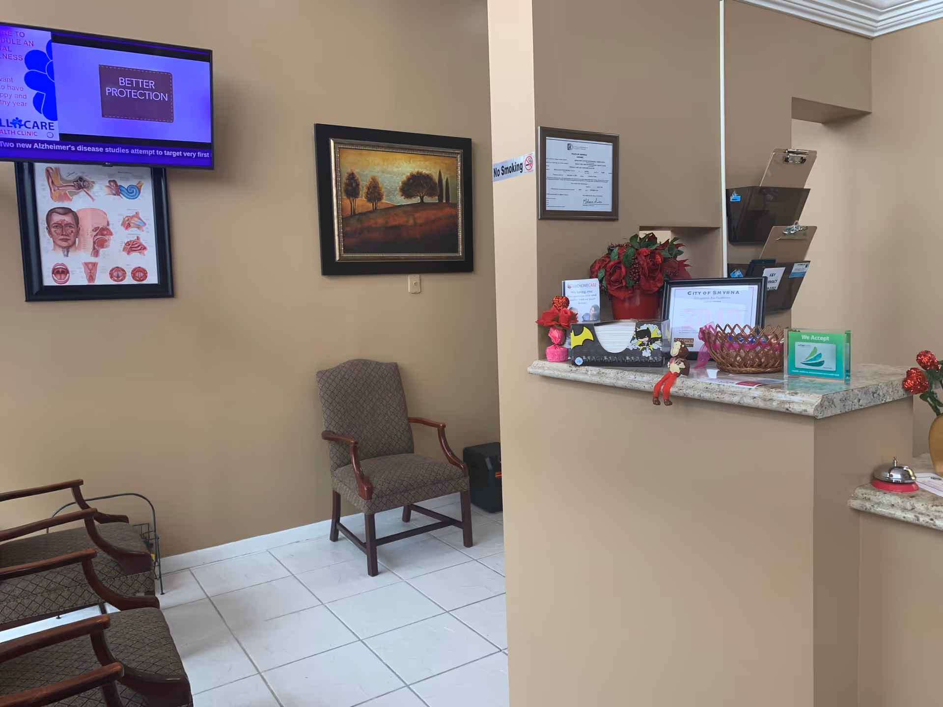 Reception area of Wisba Home Health Care with chairs, counter, and wall decor.