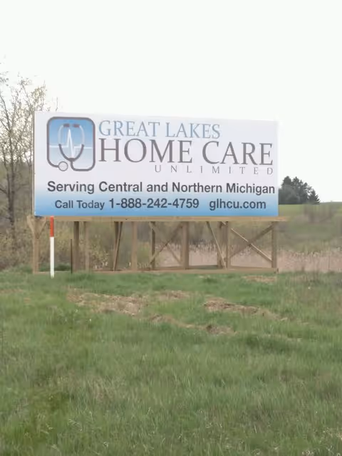A roadside billboard advertising Great Lakes Home Care Unlimited in Michigan.