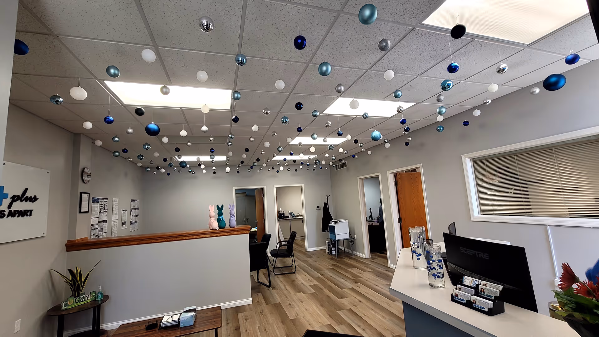 Interior reception lobby featuring a front desk, seating, and decorative ceiling ornaments.