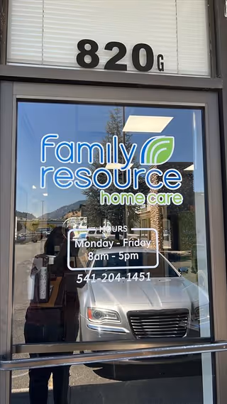 Storefront door with Family Resource Home Care logo and hours on glass
