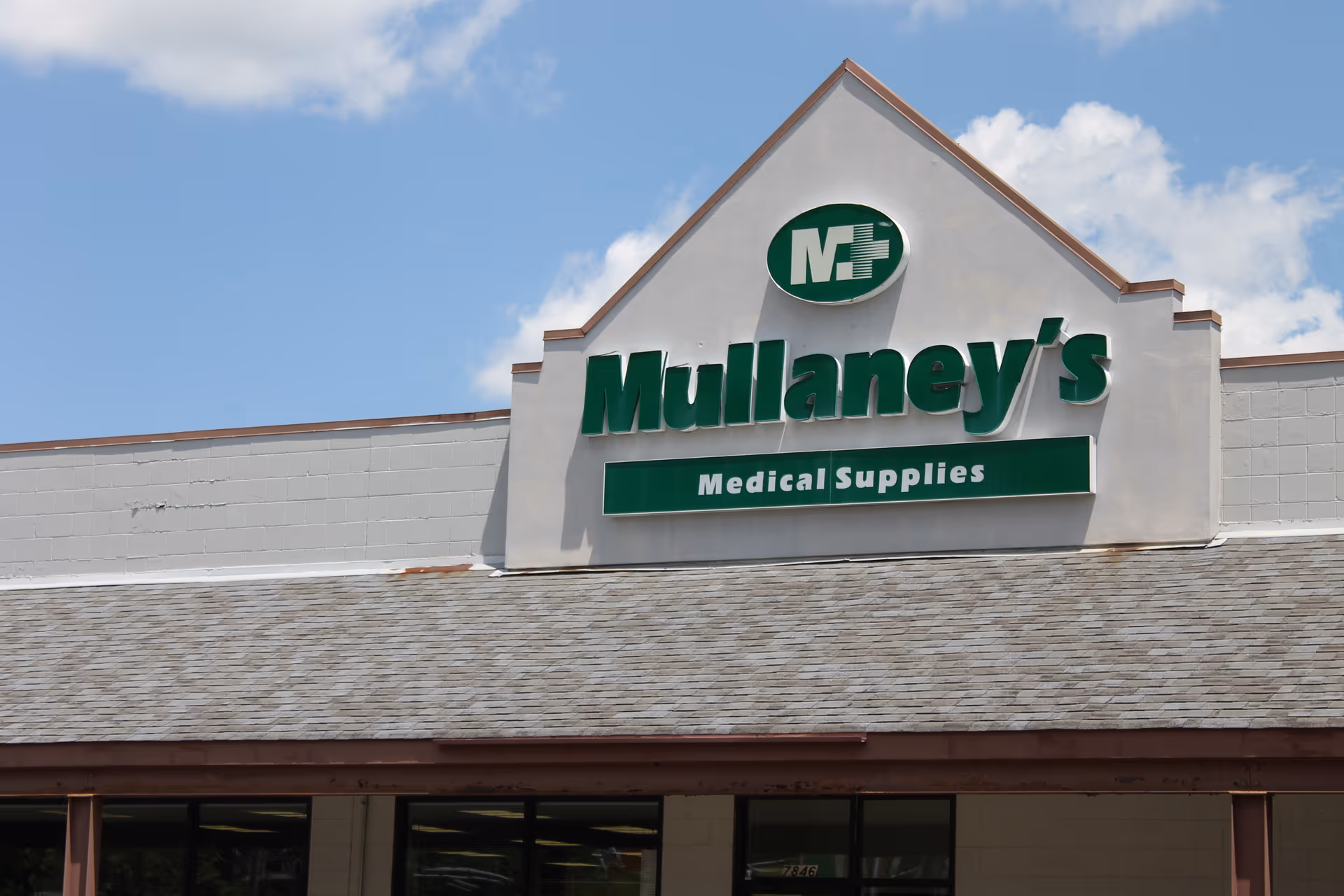 Front view of Mullaney's Medical Supplies storefront sign on a beige building.
