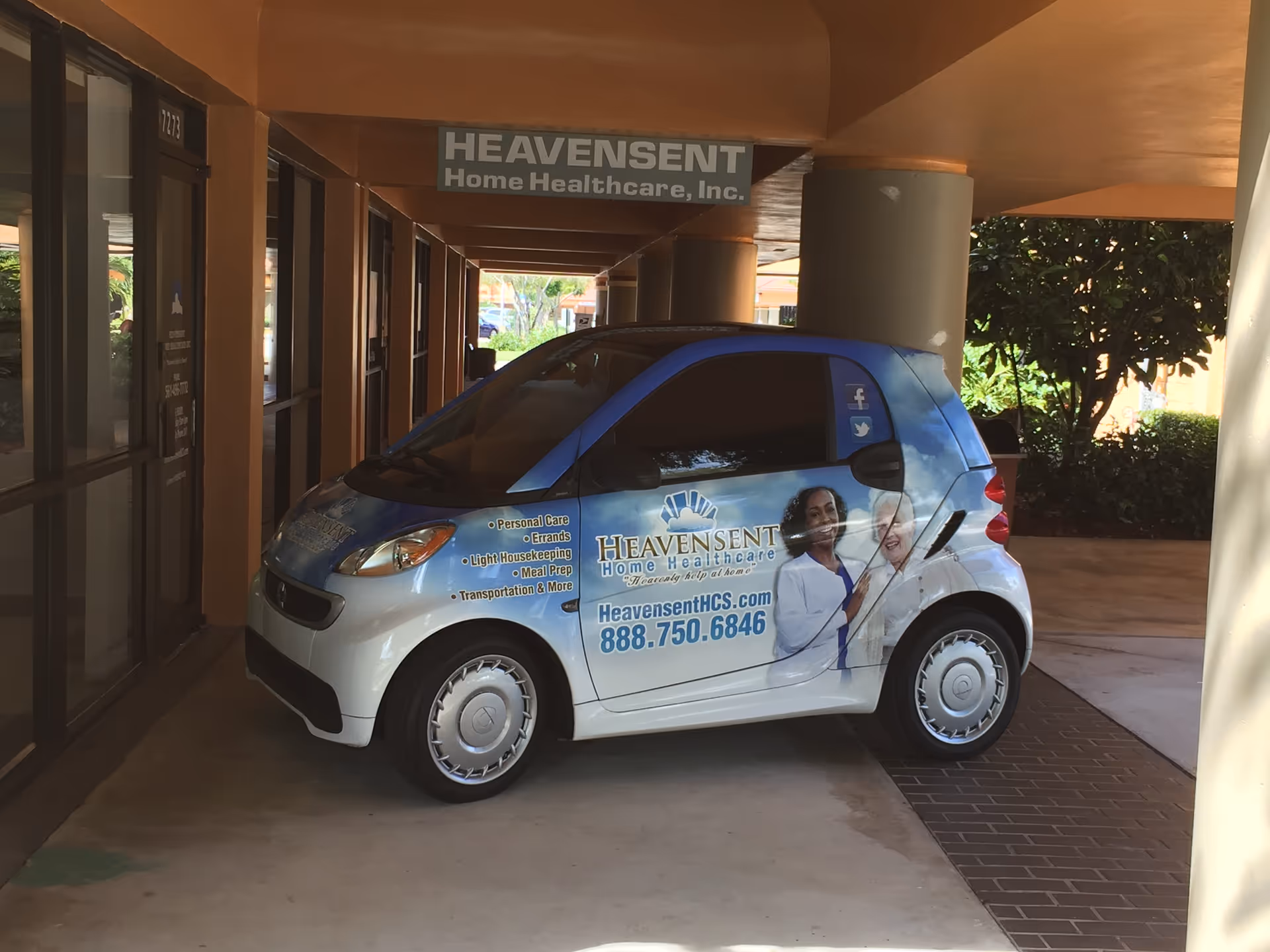 Branded Heavensent Home Healthcare van parked beside the building front entrance.
