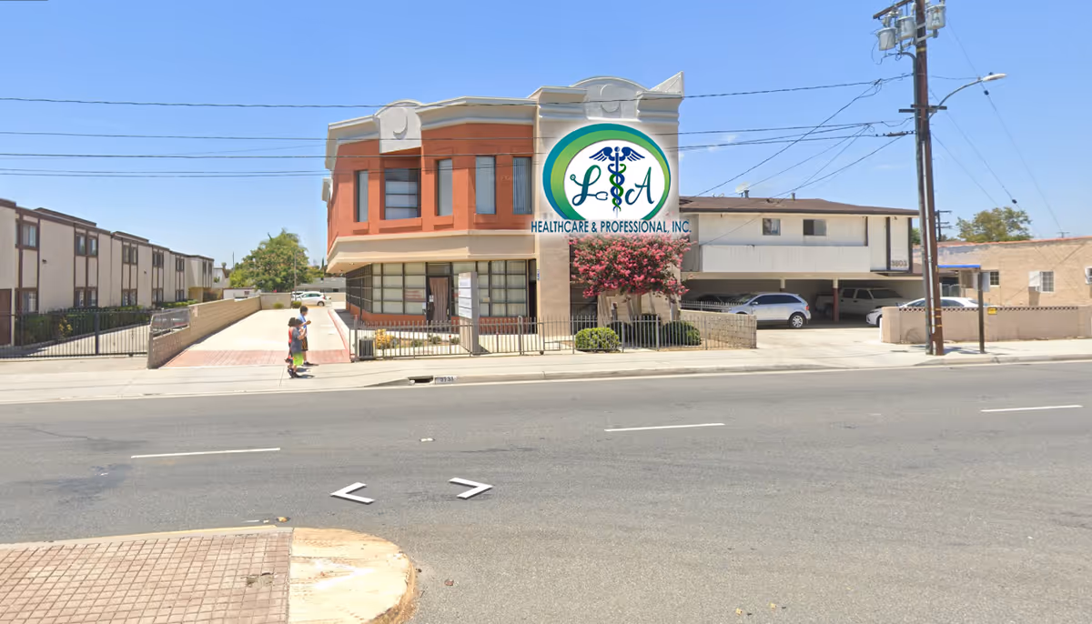 Front exterior of LA Healthcare & Professional Inc. building with sign, cars, and sidewalk.