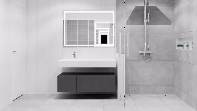 Modern bathroom with a wall-mounted sink, mirror, and glass-enclosed shower.