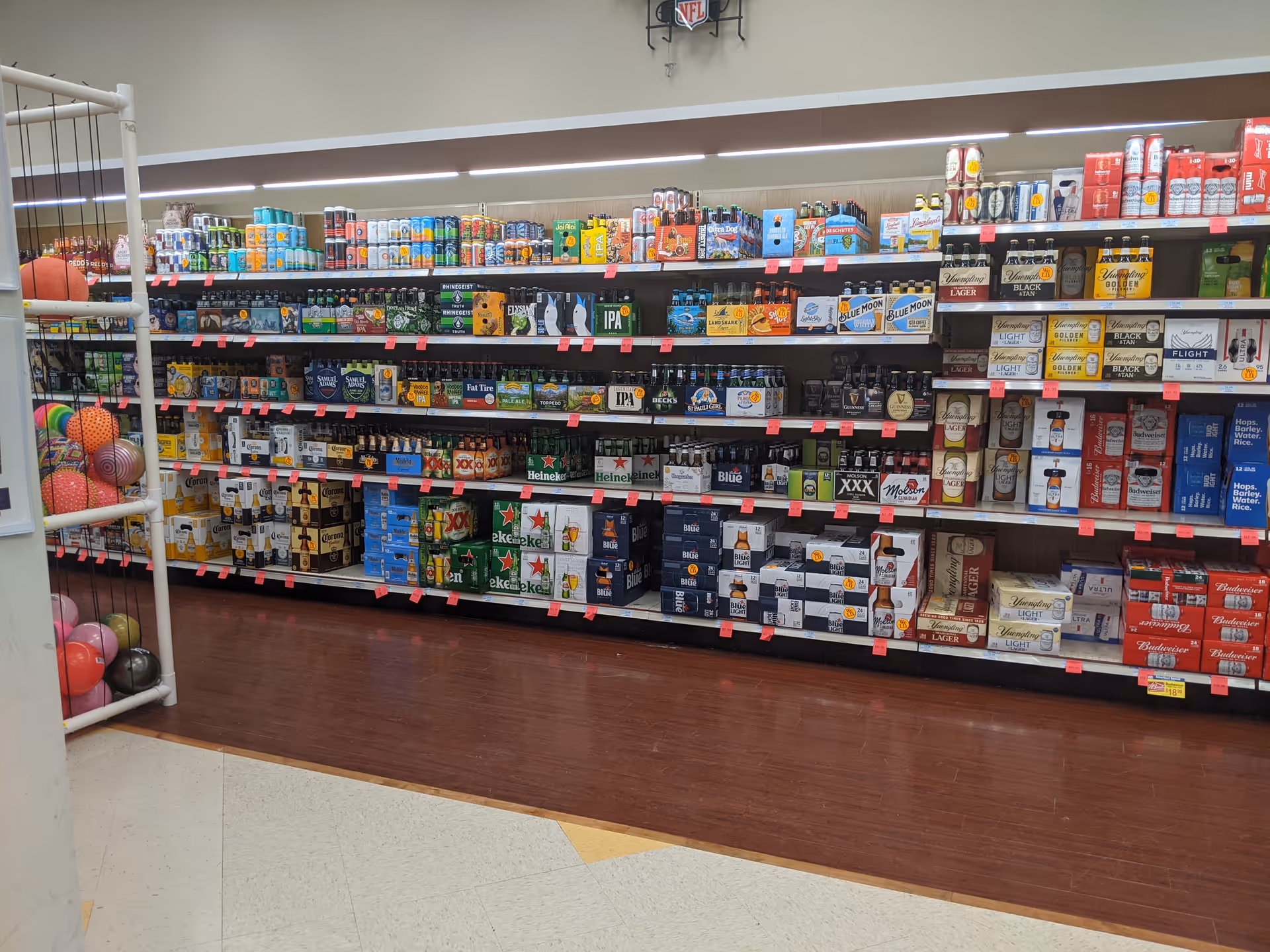 Interior store aisle with beer and beverage boxes on shelves.