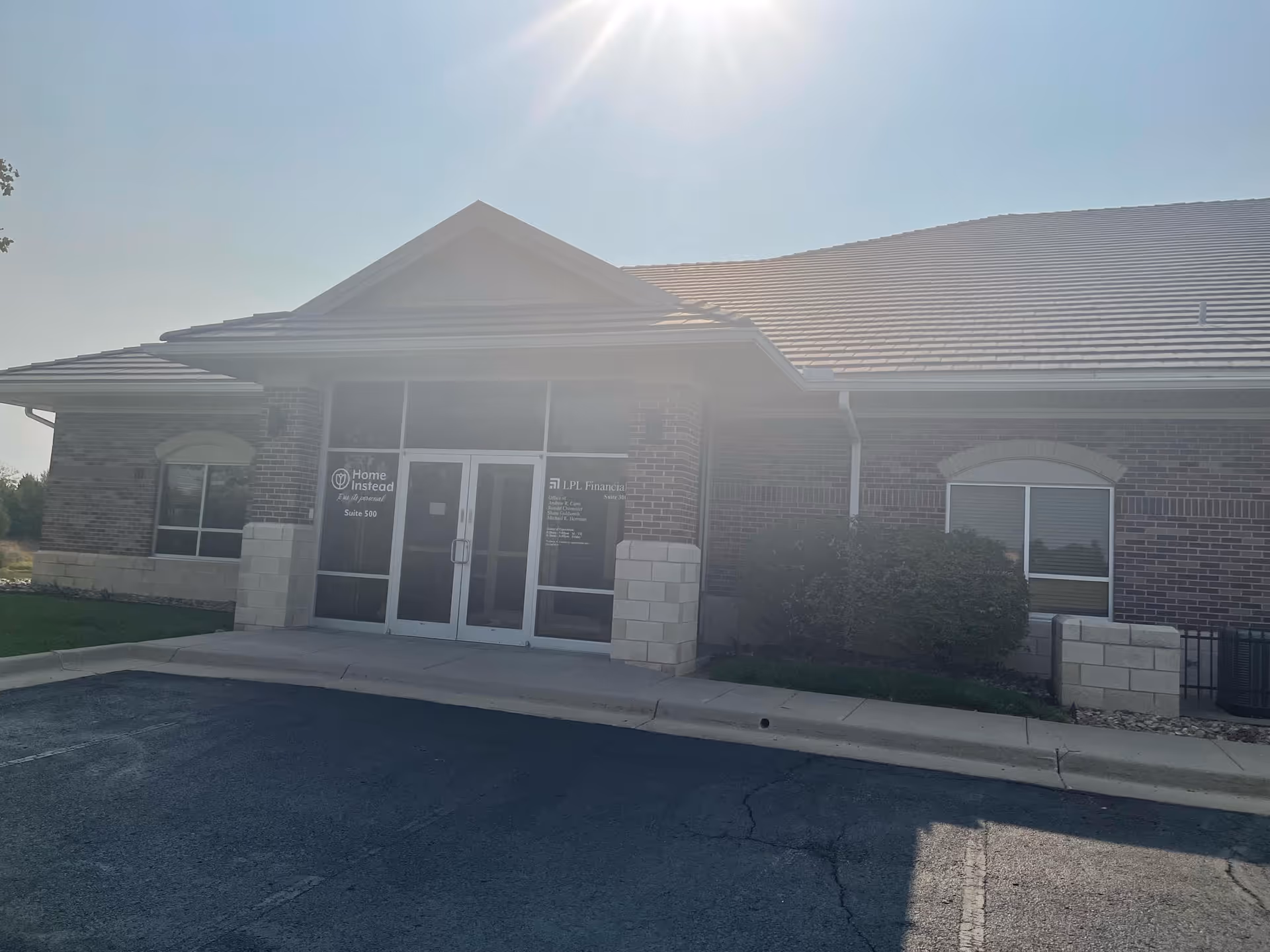 Front view of a Home Instead senior living facility entrance.