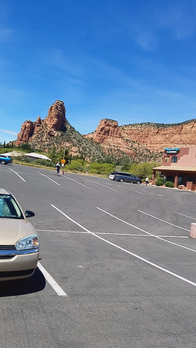 Parking lot in front of a Compassus facility with red rock mountains in the background.