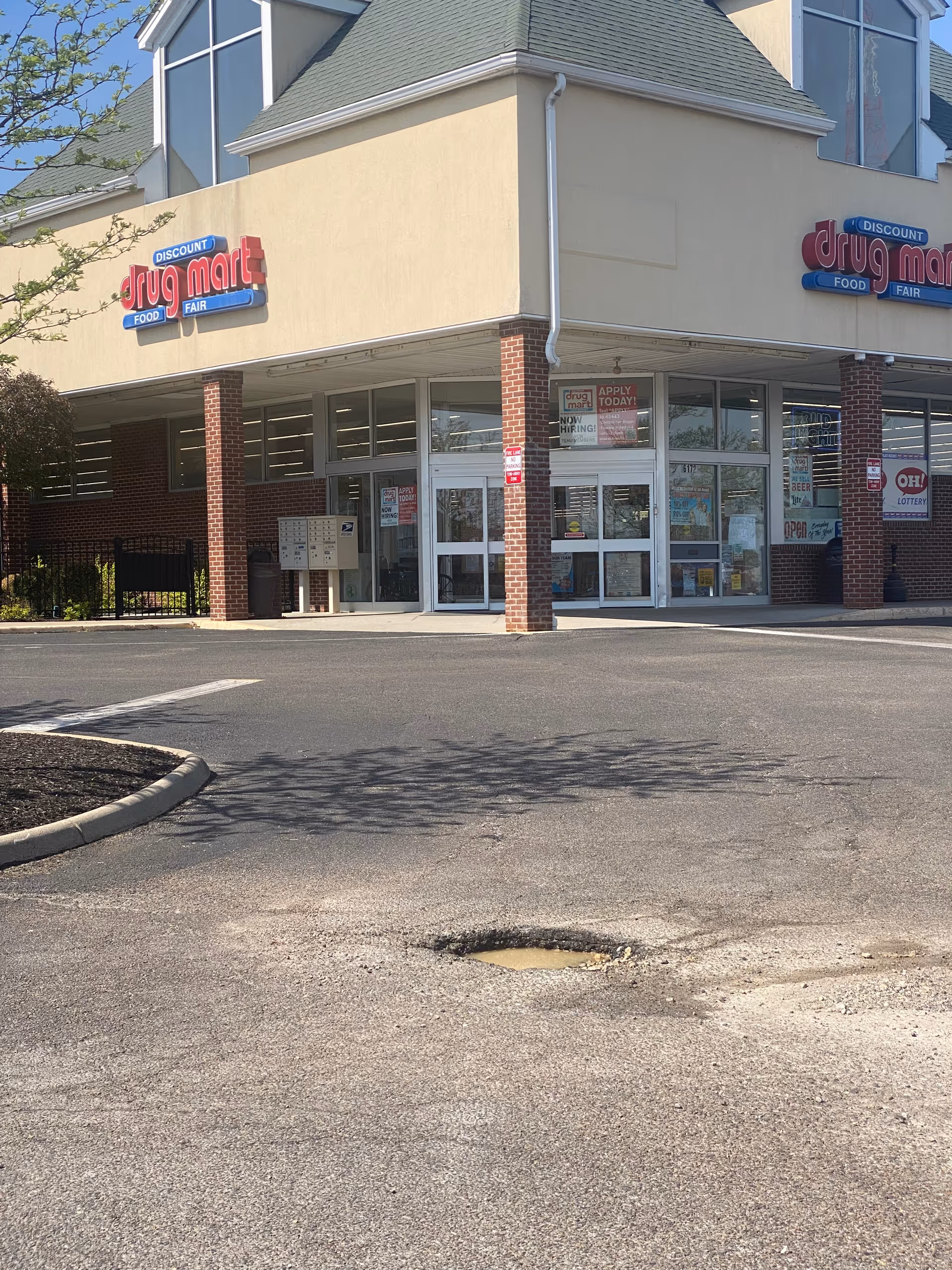 Discount Drug Mart storefront with large windows and brick columns at a shopping plaza.