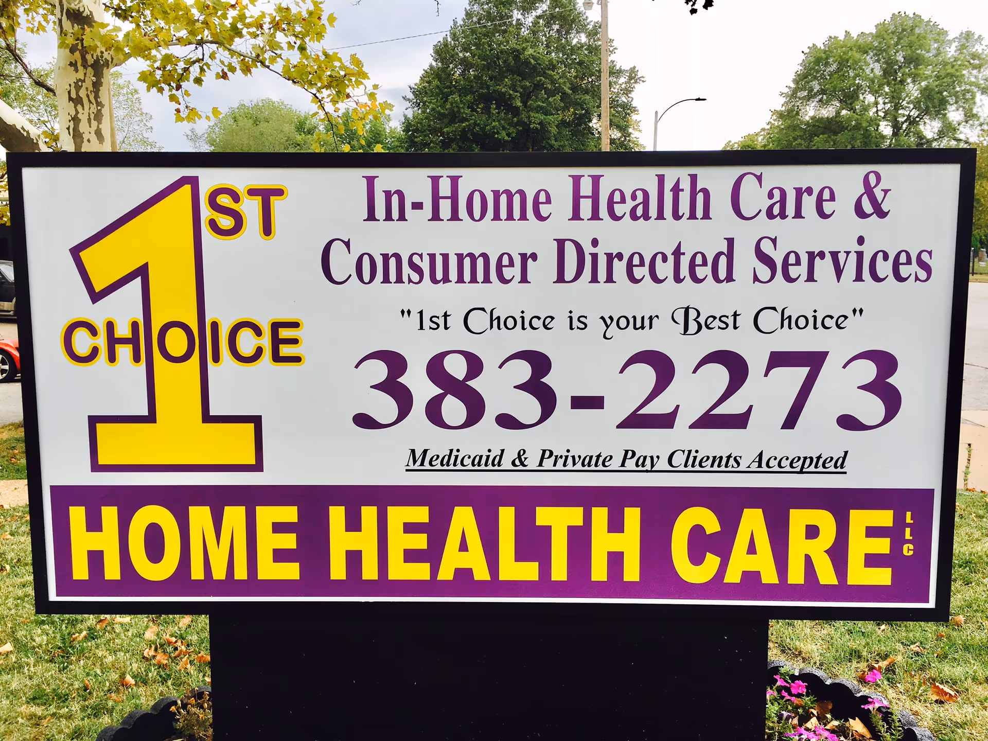 Outdoor sign advertising 1st Choice Home Health Care with purple and yellow lettering.