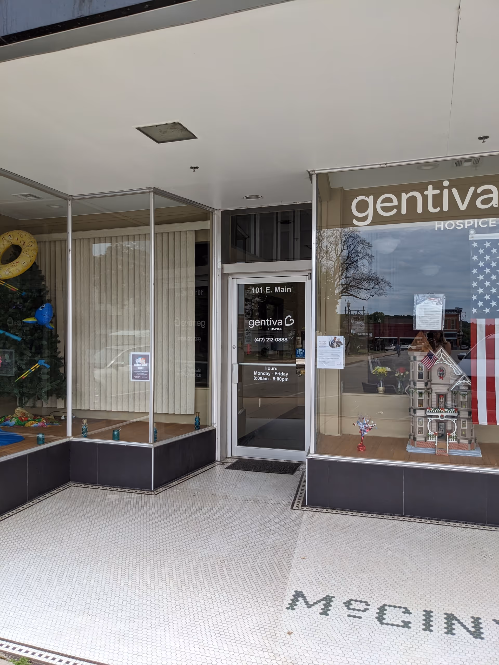 Entrance to Gentiva Hospice building with glass doors and signage.