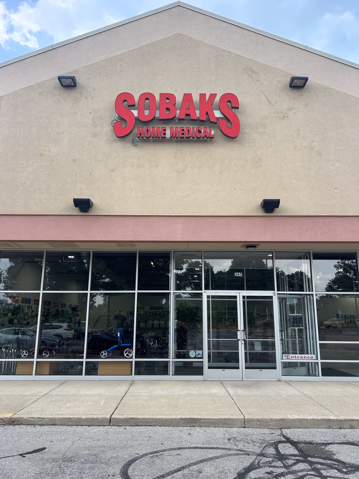Front exterior of Sobaks Home Medical storefront with large red sign.