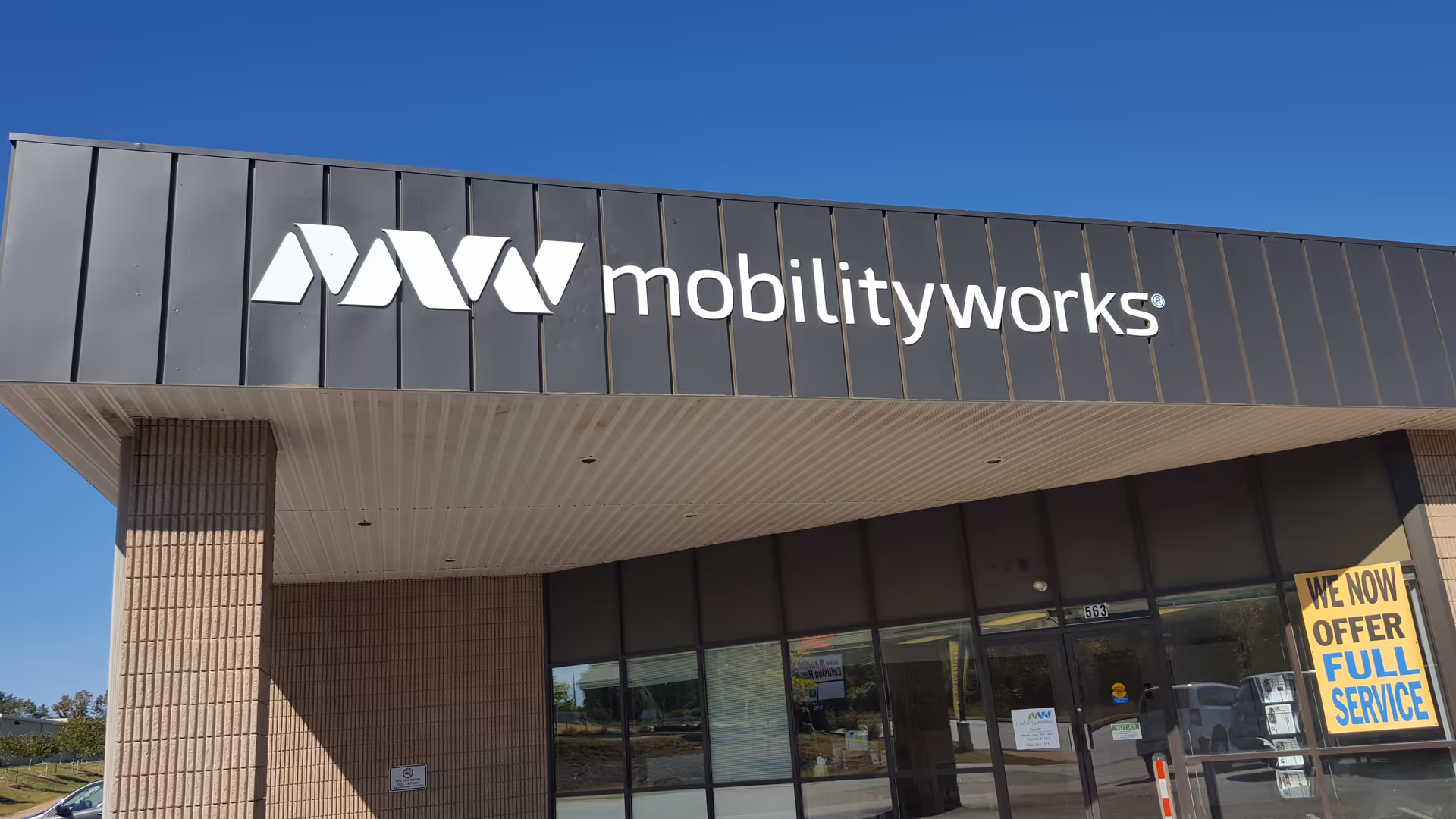 Exterior view of MobilityWorks storefront with logo and glass entrance doors.