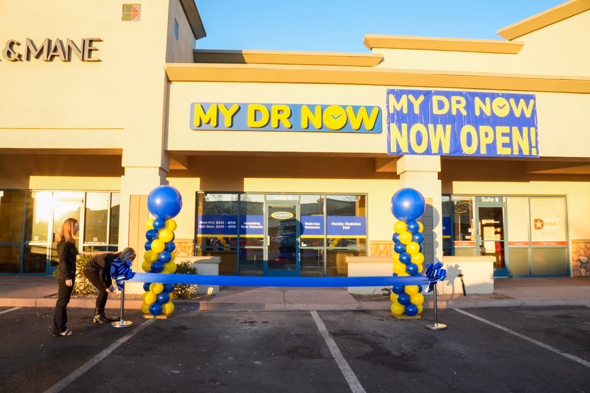 MY DR NOW storefront with banners, balloon columns, and a ribbon-cutting ceremony at the entrance.