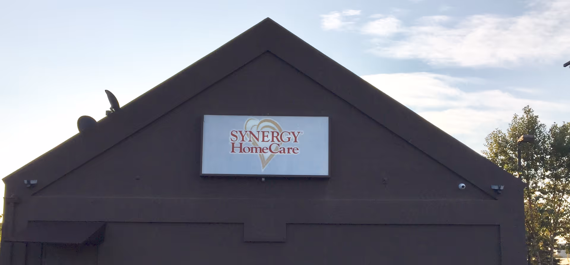 Front exterior of a building with a Synergy HomeCare sign on the facade.