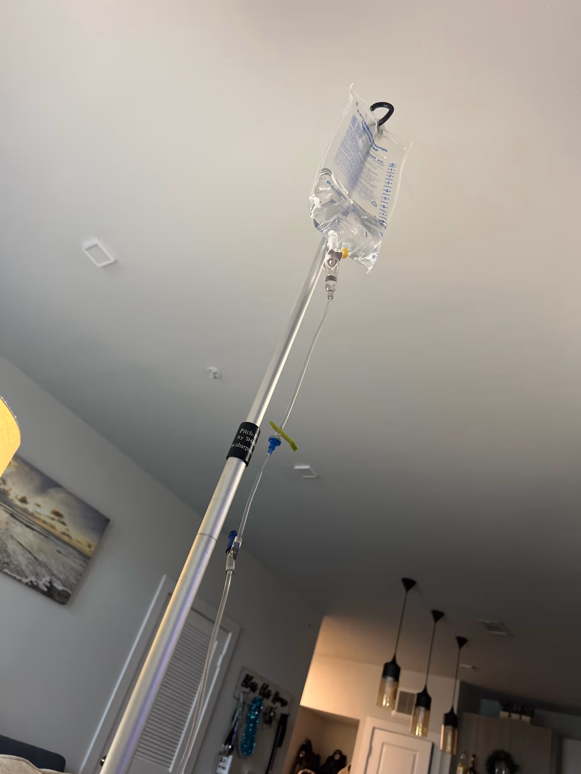 IV drip pole with a bag in a modern interior living space.