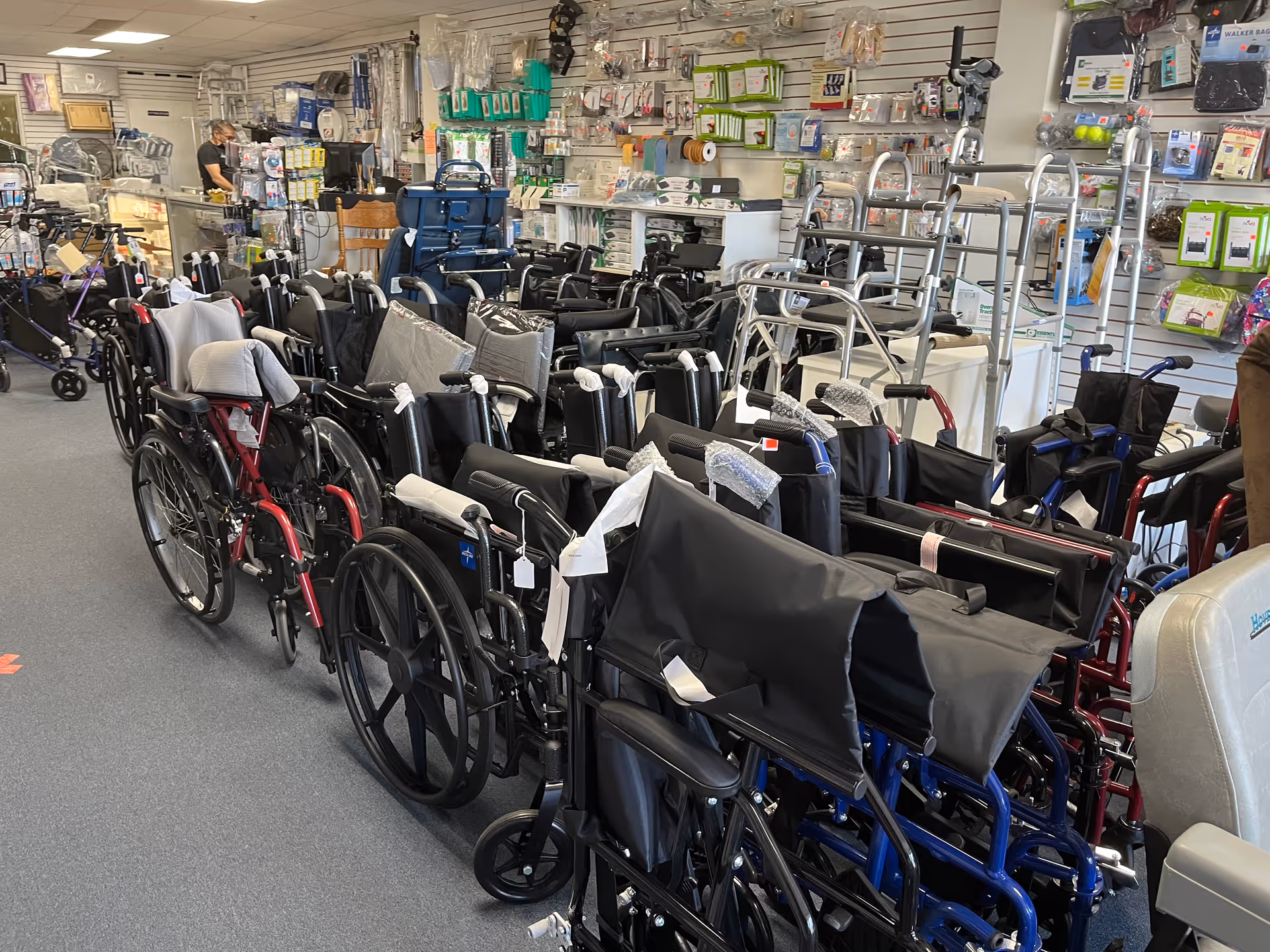 Row after row of wheelchairs and mobility devices in a medical supply store.