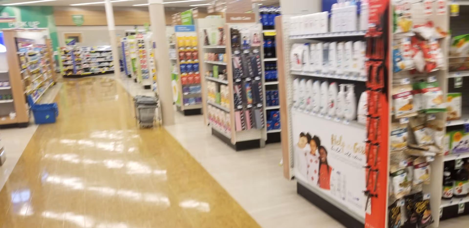 Blurred interior view of a Discount Drug Mart store with aisles and shelves.