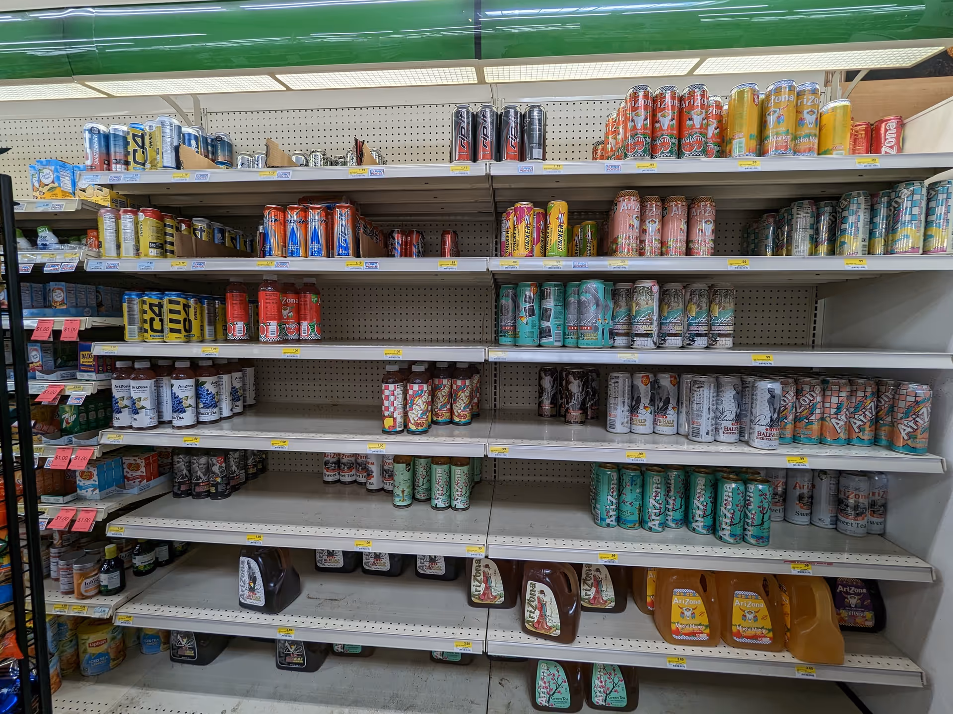 A grocery-style beverage aisle with assorted canned drinks on shelves.