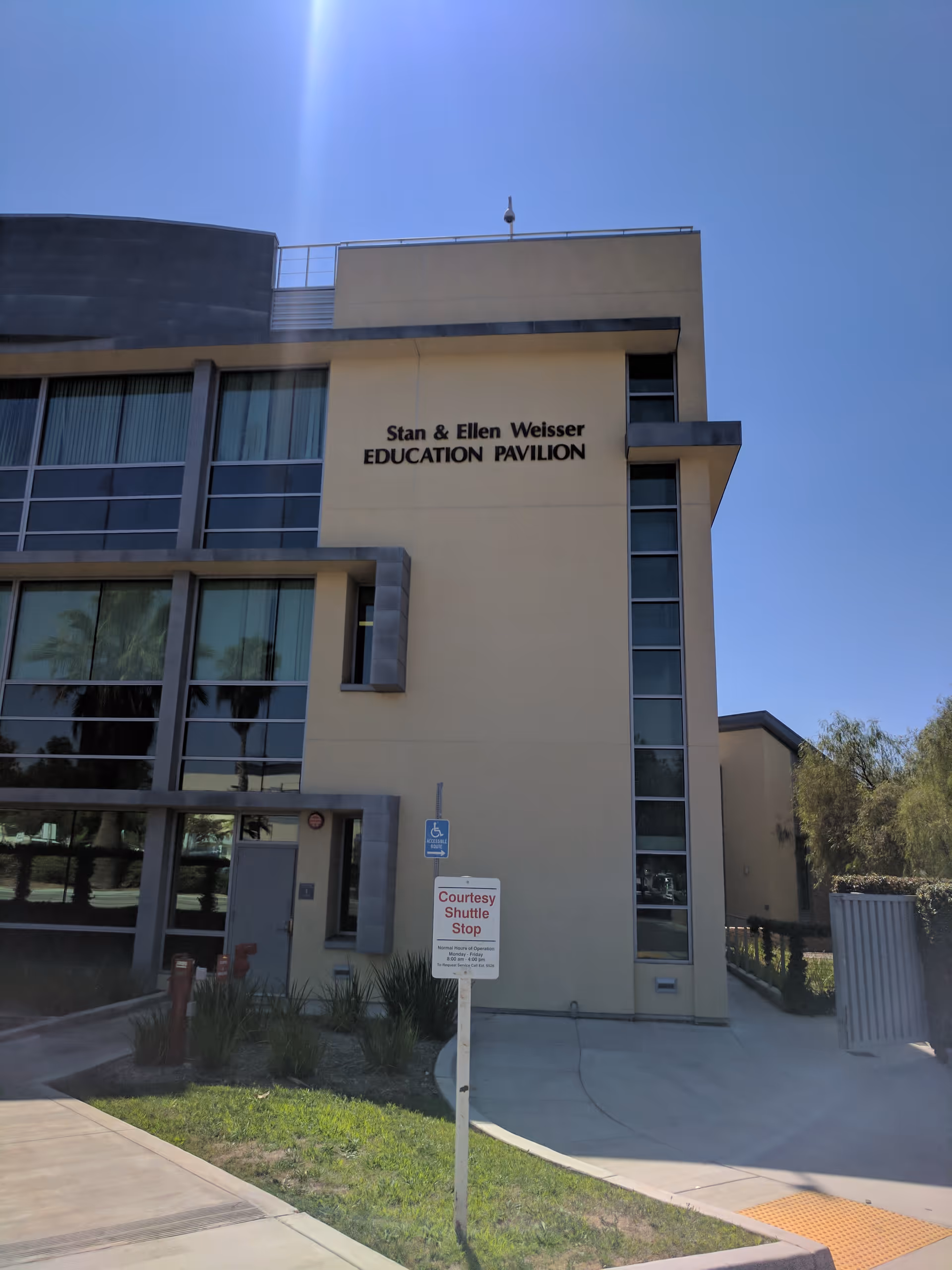 Facade of Stan and Ellen Weisser Education Pavilion at Redlands Community Hospital, with sign and walkway.