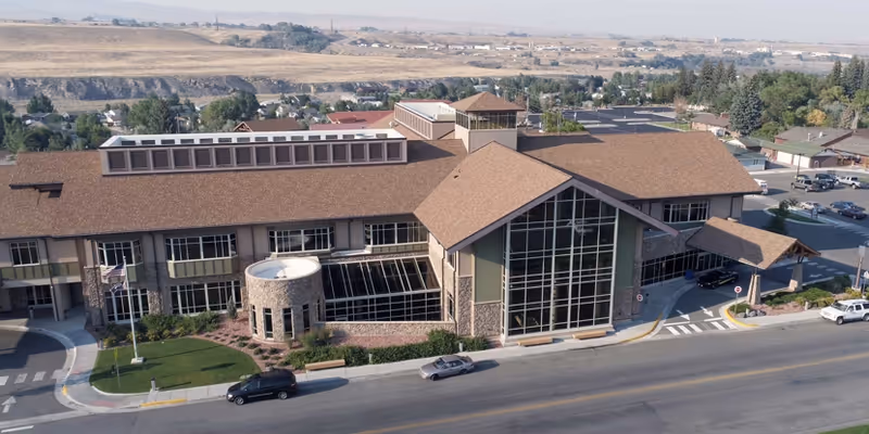 Aerial view of Cody Regional Health Long Term Care Center with brown roof and glass facade.