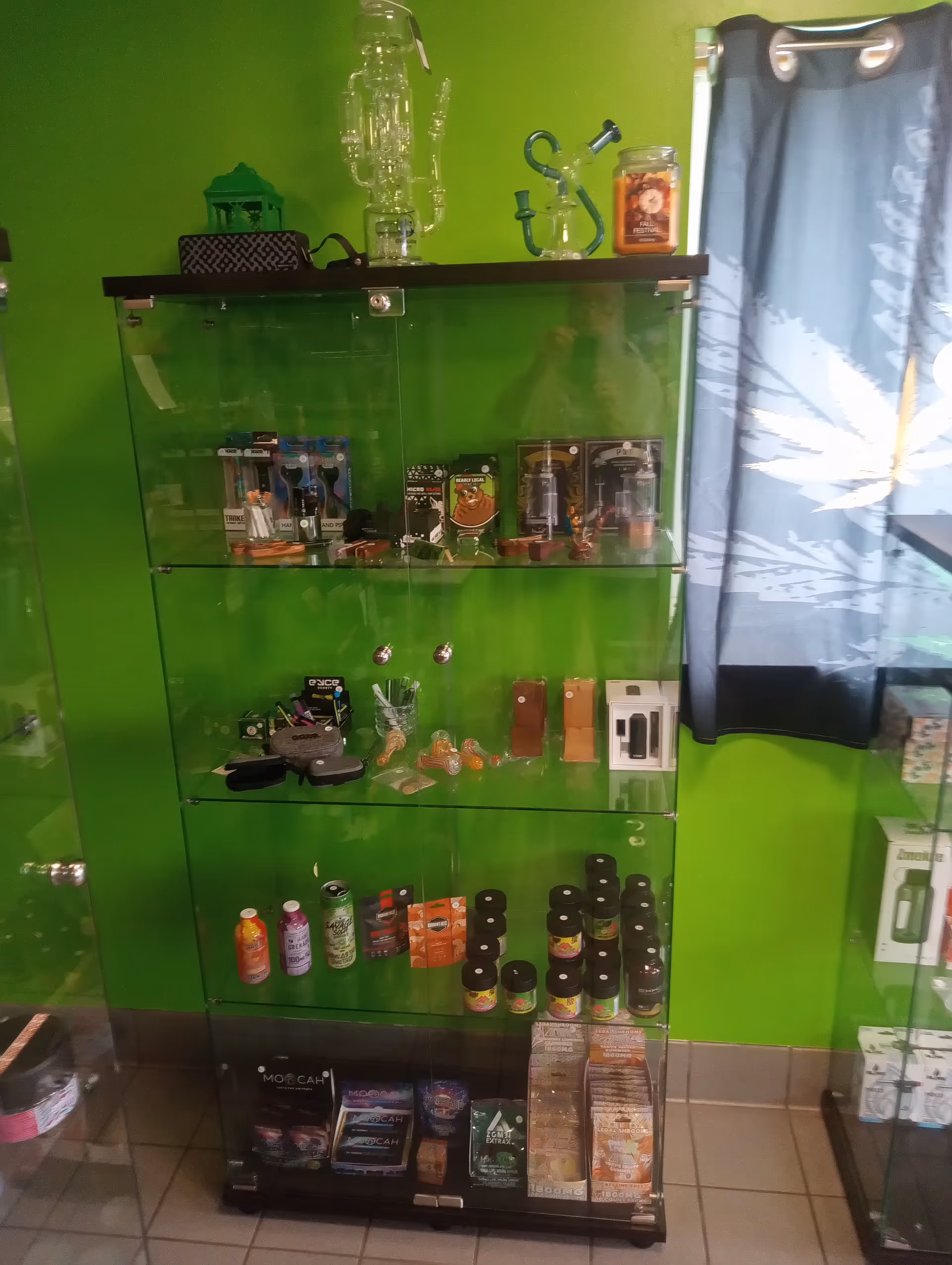 Interior of The Healing Garden featuring a lime-green wall and a glass display cabinet.