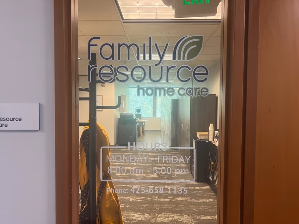 Glass door displays Family Resource Home Care sign; office hallway visible behind.