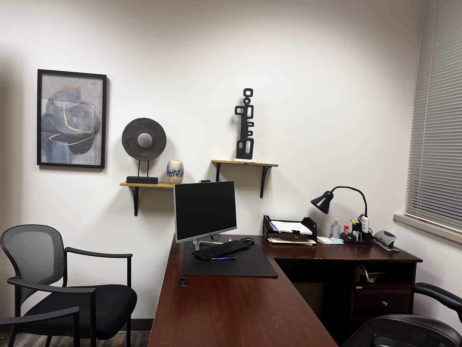 Office workspace inside a senior living facility with desk, computer, and decor.