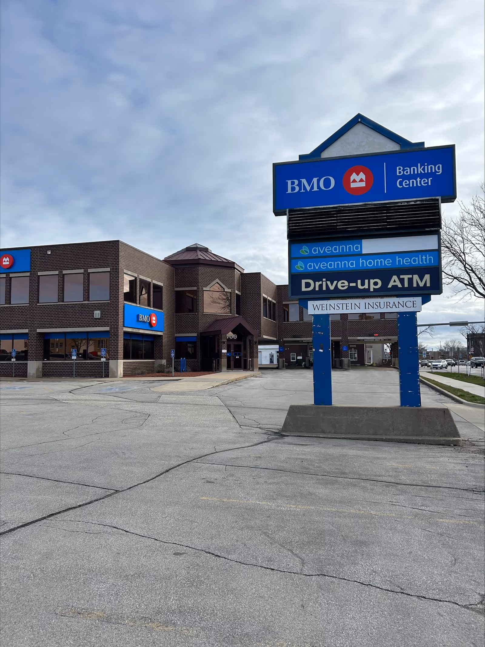 Exterior view of a storefront area with BMO Bank signs and Aveanna Home Health signs.