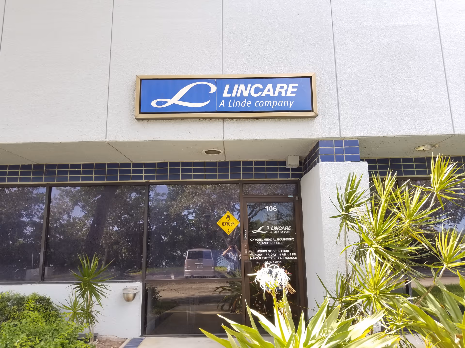 Exterior view of LINCARE facility entrance with blue sign and glass doors