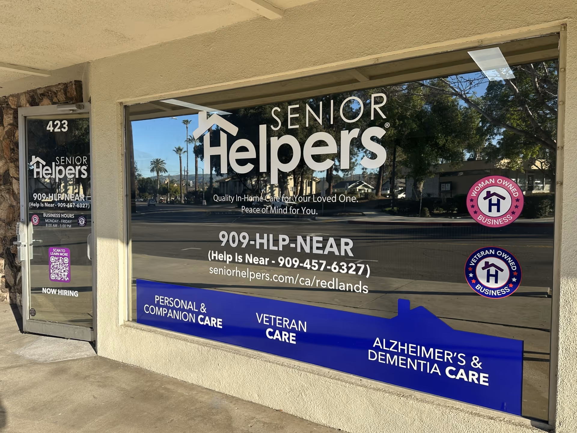 Beige building storefront displays Senior Helpers signage in large window.