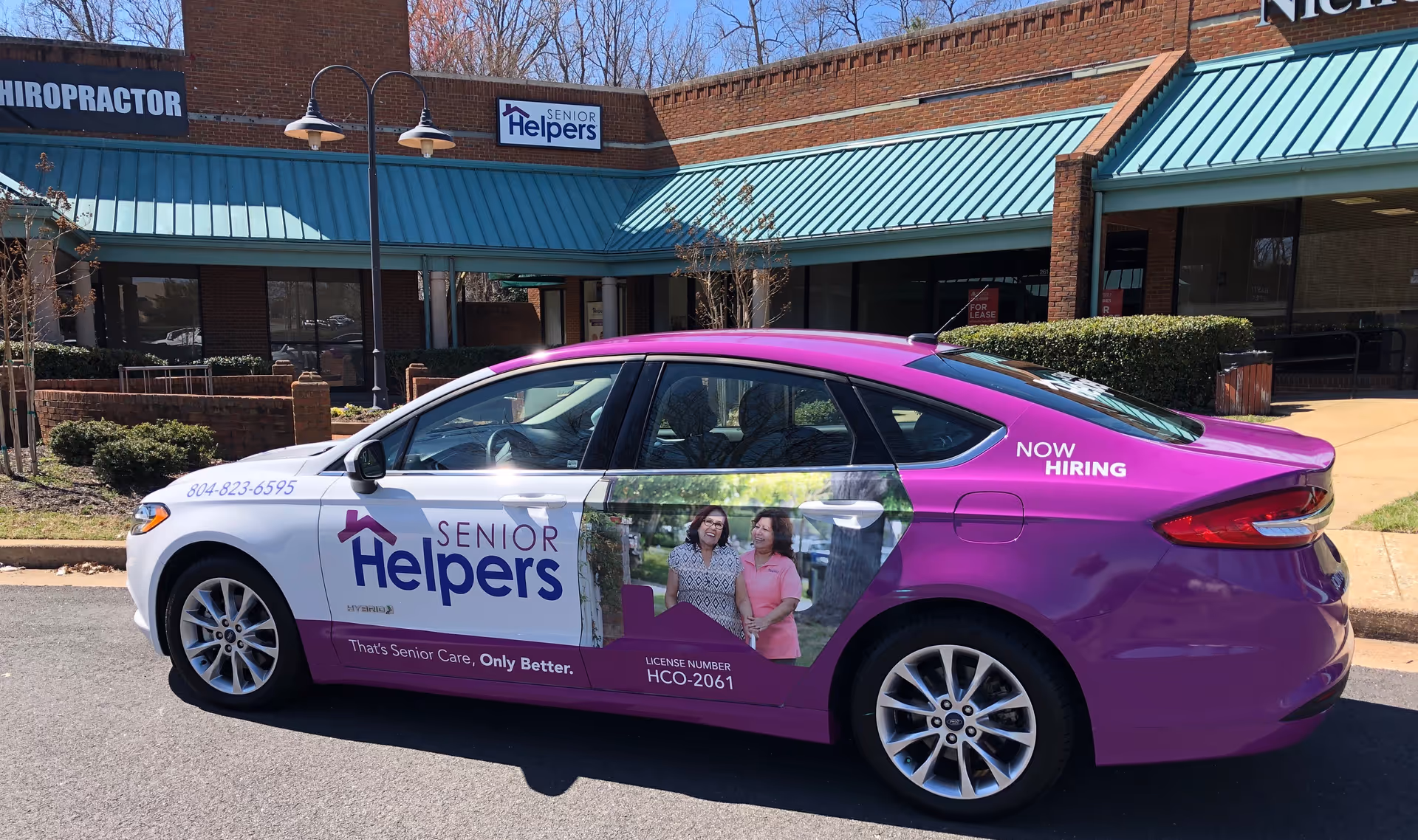 Promotional Senior Helpers car parked outside a Senior Helpers facility.
