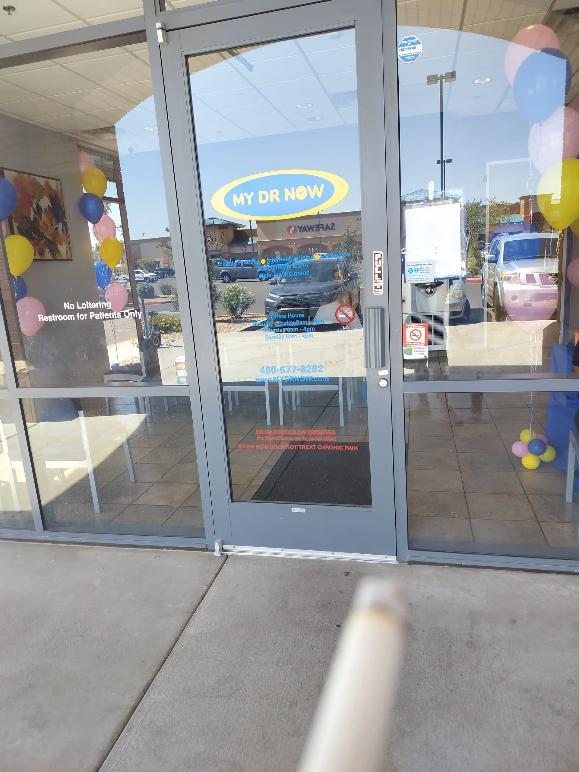 Front entrance of MY DR NOW with glass doors, balloons, and signage visible inside.
