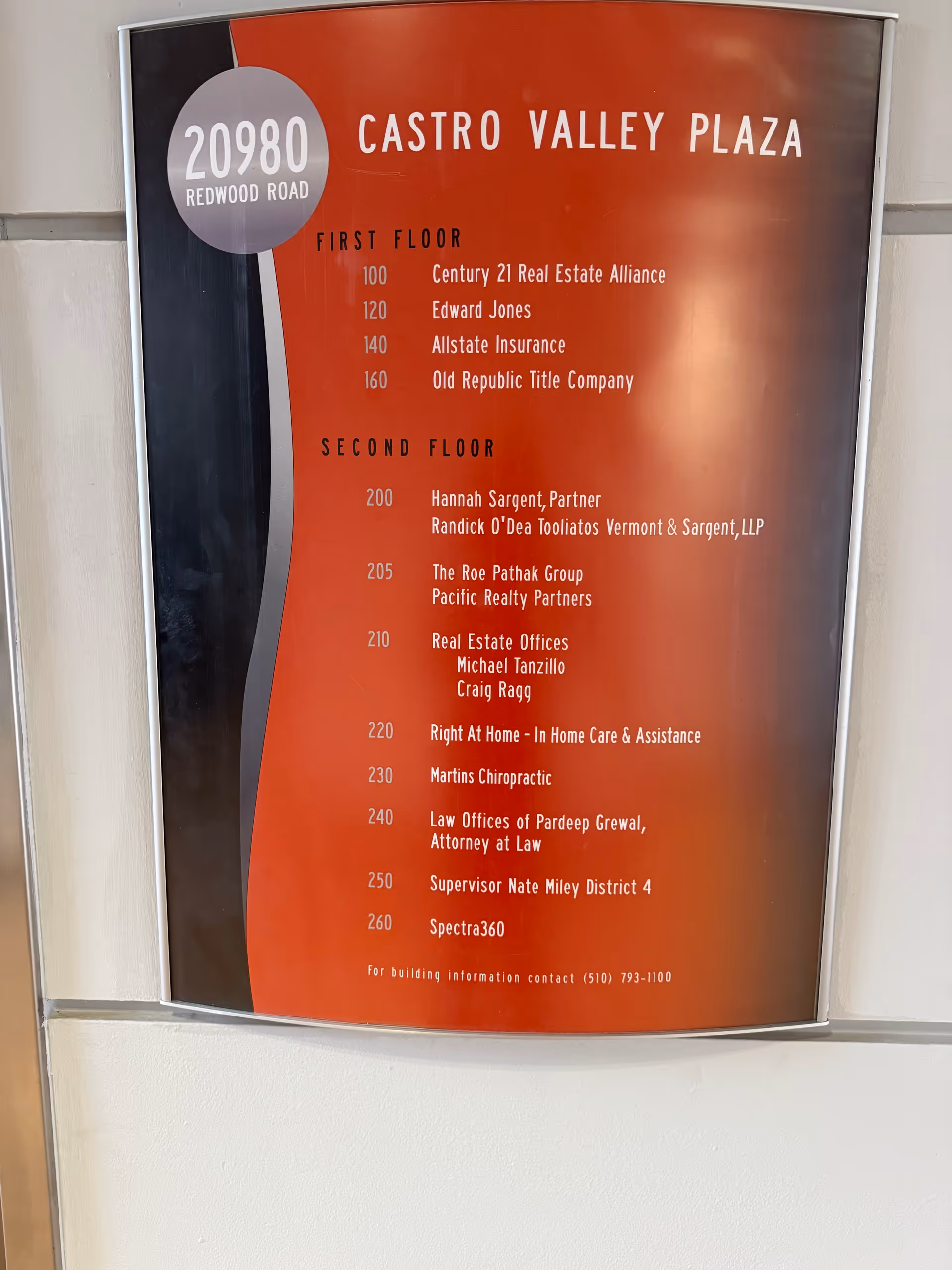 Interior directory sign on wall listing offices and floor numbers.