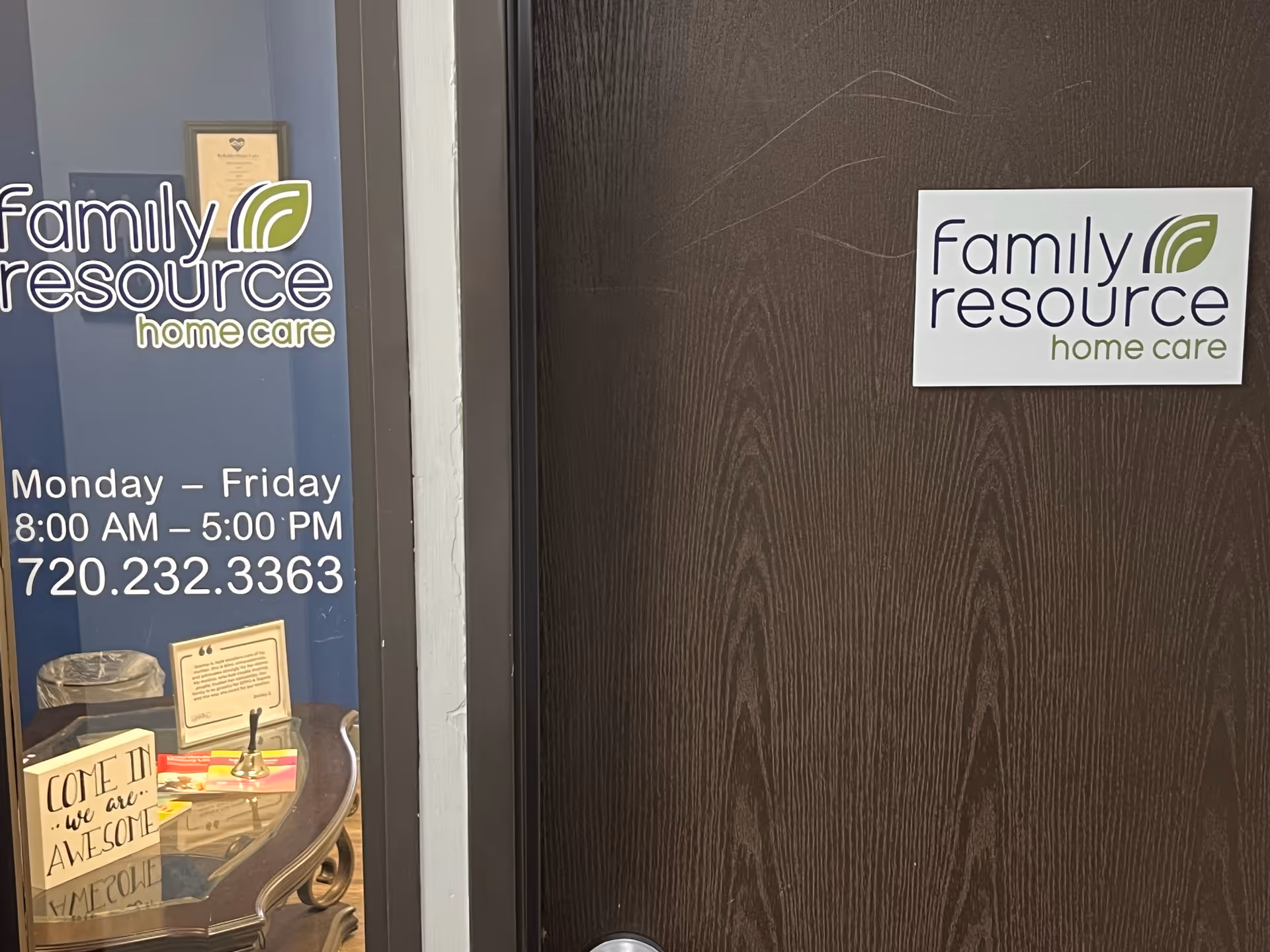 Entrance of Family Resource Home Care with logos on glass and a wooden door.