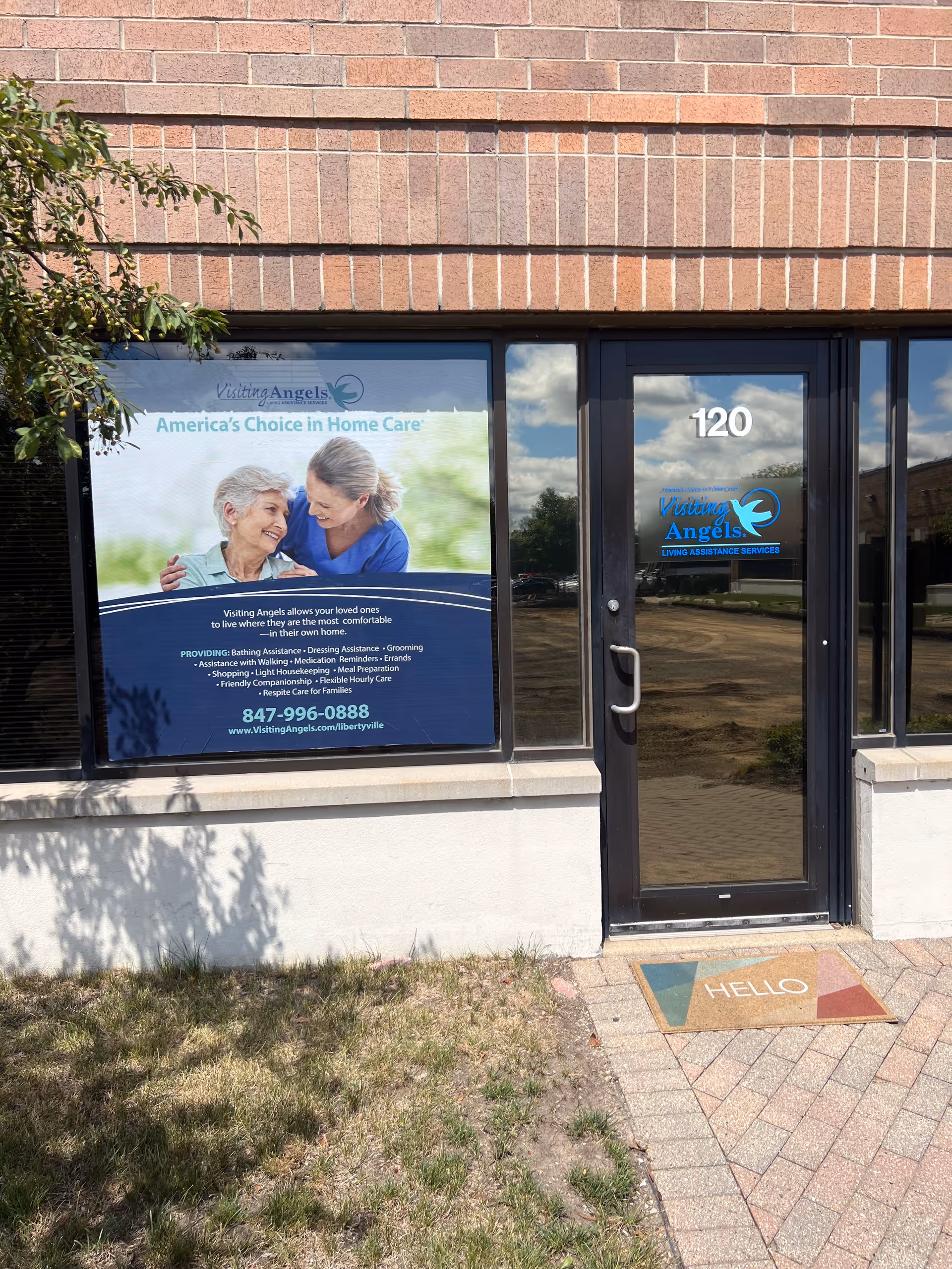 Exterior view of Visiting Angels Senior Home Care entrance with window signage.