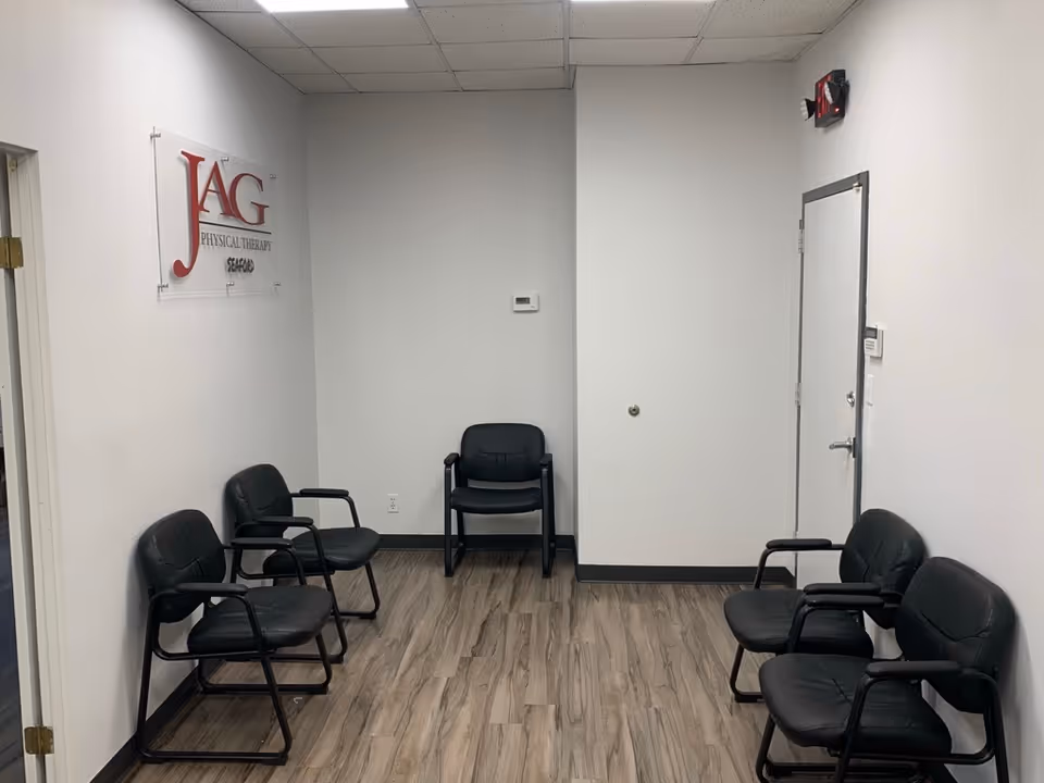 Small waiting room with black chairs and a JAG Physical Therapy sign.