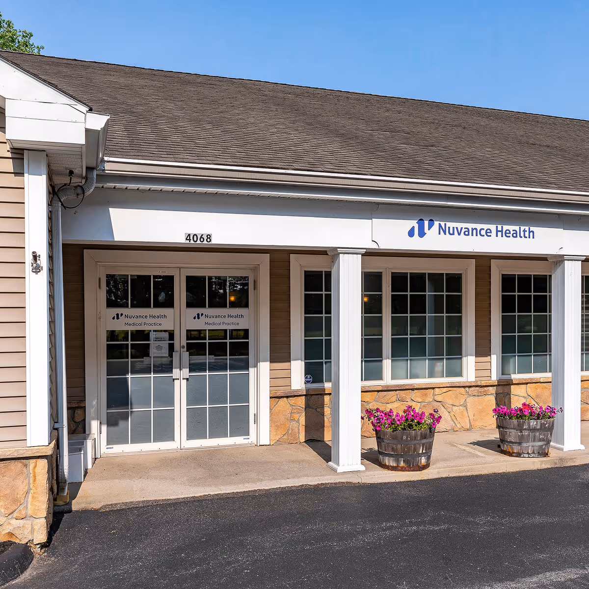 Exterior view of Nuvance Health Rheumatology Hyde Park clinic with entrance and planters.