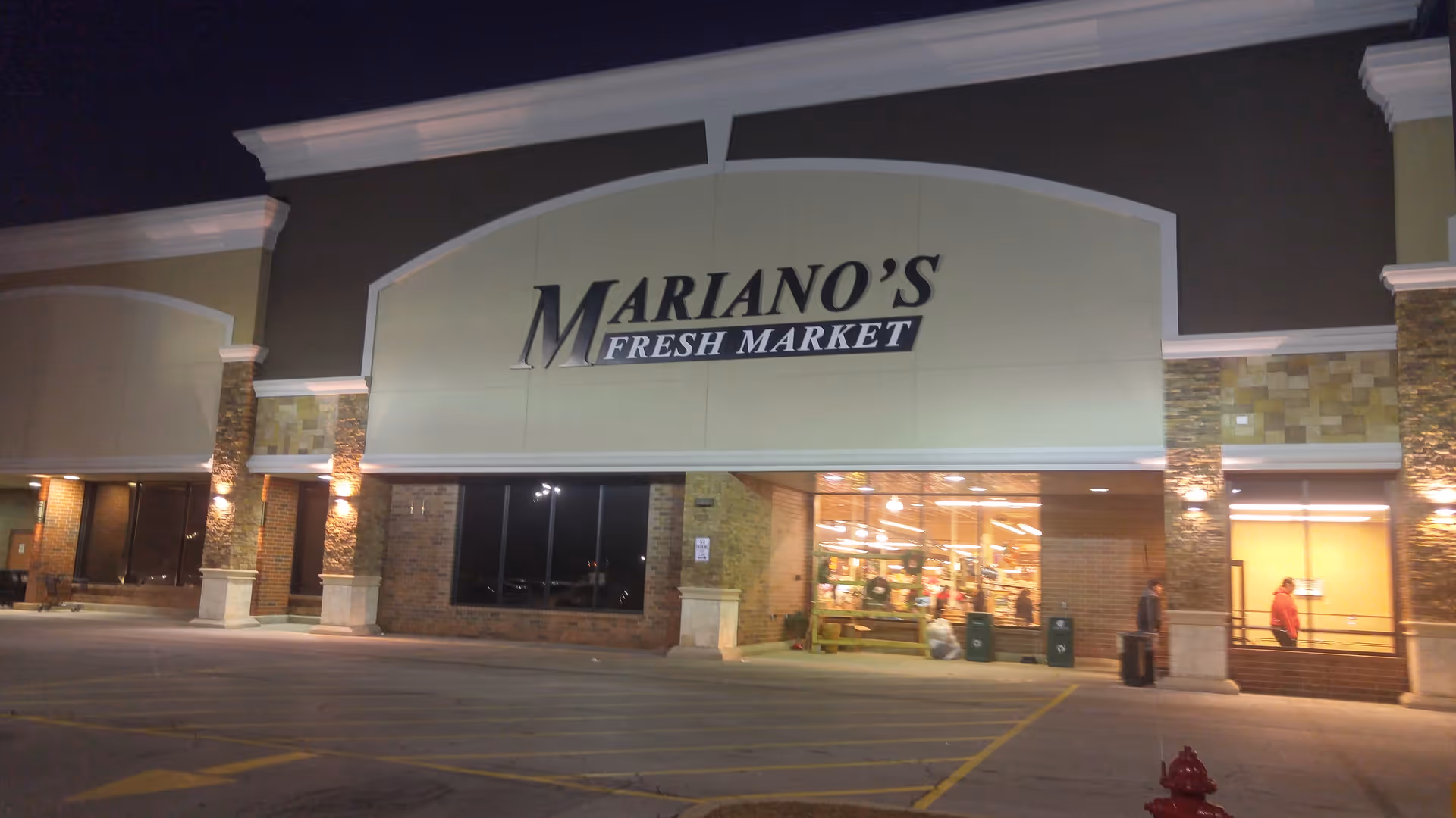 Exterior view of Mariano's Fresh Market storefront lit at night