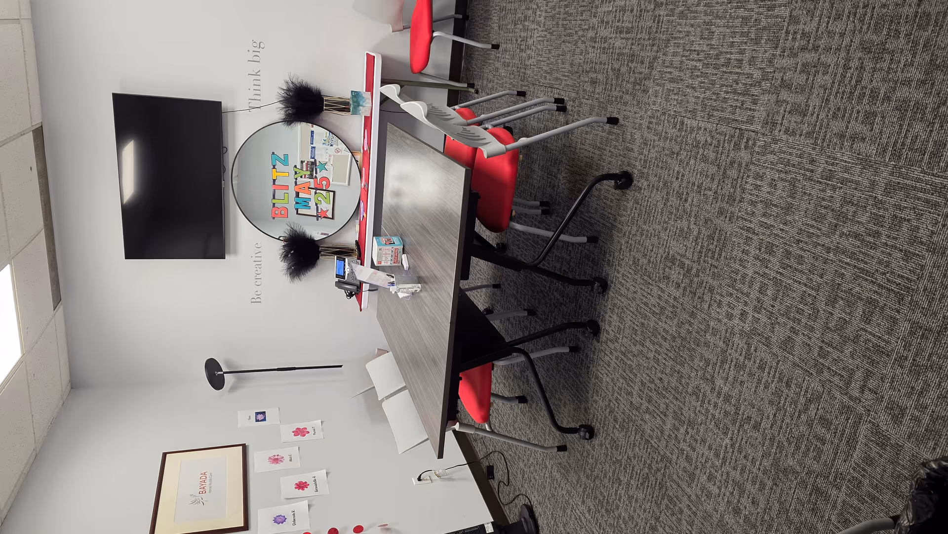BAYADA Assistive Care conference room with a table and red chairs.