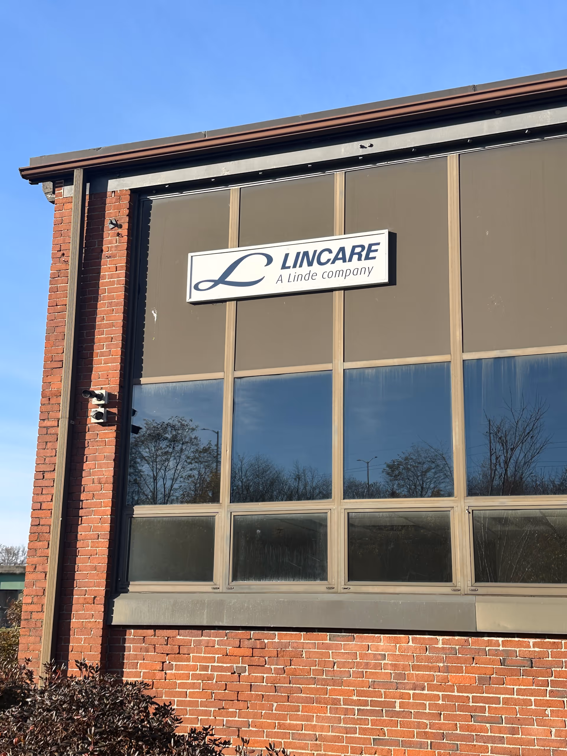 Exterior of a LINCARE facility with brick walls and large window panels.