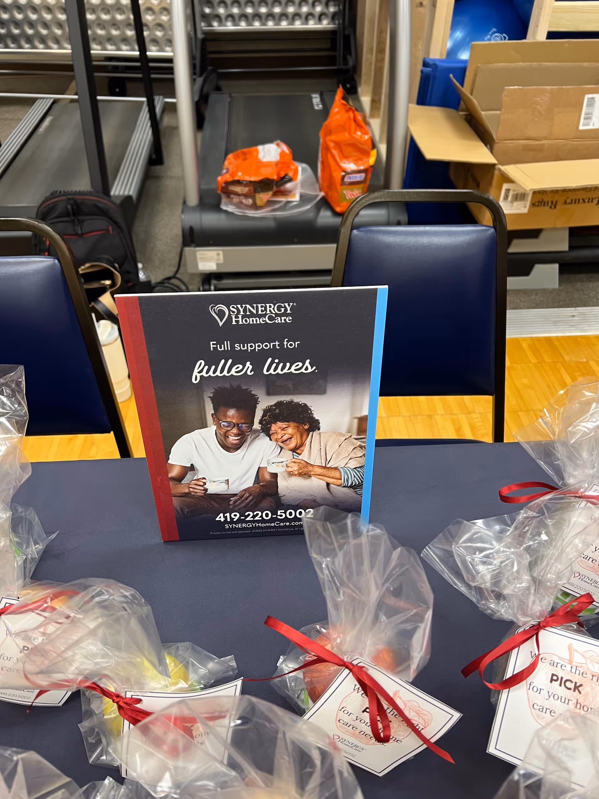 Synergy HomeCare brochure on a table inside a facility lobby.